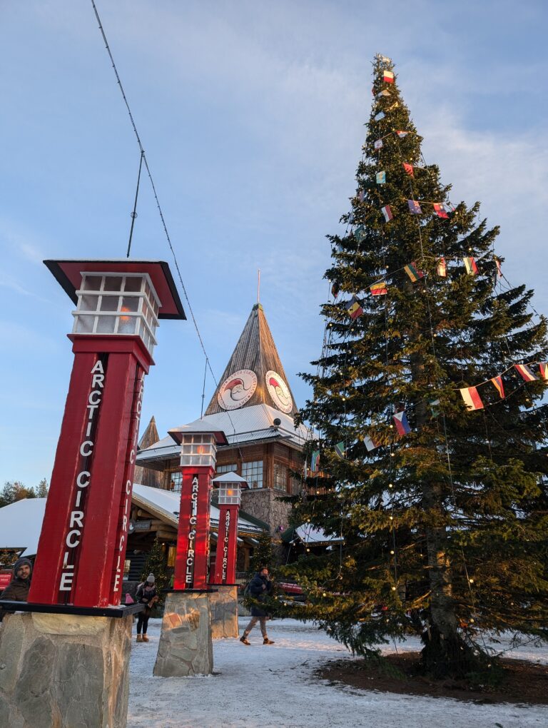 Santa Claus Village with Arctic Circle poles and Christmas tree